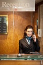 Attractive young receptionist receiving calls Royalty Free Stock Photo