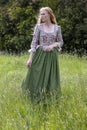 Red-haired 18th century woman wandering in the wilderness