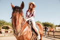Attractive young redhead cowgirl in hat riding her horse Royalty Free Stock Photo