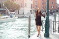 Travel tourist woman on pier against beautiful view on venetian chanal in Venice, Italy. Royalty Free Stock Photo