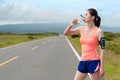 Attractive young runner woman drinking water Royalty Free Stock Photo