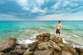 Attractive young shirtless athletic man lost on isolated island standing on rock Royalty Free Stock Photo