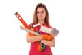 Attractive young slim builder girl makes renovations with tools in her hands isolated on white background Royalty Free Stock Photo