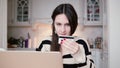 Attractive young smiling woman uses plastic credit card shopping online with laptop. Royalty Free Stock Photo