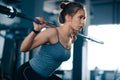 Attractive Young Sports Woman Doing Squats with Barbell in the Gym. Fitness and Healthy Lifestyle. Royalty Free Stock Photo