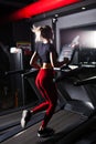 Attractive young sports woman is working out in gym. Doing cardio training on treadmill. Running on treadmill. Royalty Free Stock Photo