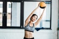 Young sportswoman holding ball while working out in gym Royalty Free Stock Photo