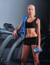 Attractive young sportswoman resting after running on treadmill Royalty Free Stock Photo