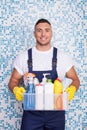 Attractive young stay-at-home man is cleaning his