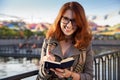 Young woman makes notes in her diary. Woman student write down new information and do a writing task.