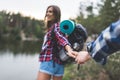 attractive young woman with backpack guiding boyfriend Royalty Free Stock Photo