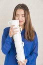 Attractive young woman balancing a pile of cups Royalty Free Stock Photo