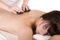 Attractive young woman being hotstone massaged Royalty Free Stock Photo