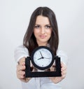 Attractive young woman and black clock Royalty Free Stock Photo