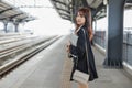 Attractive young woman in black suit holding laptop smiling looking a camera standing at public places. Lifestyle people Royalty Free Stock Photo