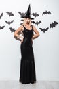 Attractive young woman in black witch costume with hat Royalty Free Stock Photo