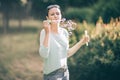 Attractive young woman blowing bubbles in summer Park Royalty Free Stock Photo