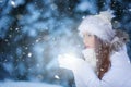 Attractive young woman blowing snow in snowy night Royalty Free Stock Photo