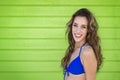 Attractive young woman in a blue bikini, with a green background. Royalty Free Stock Photo