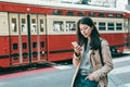 Browsing phone and standing while train passing Royalty Free Stock Photo