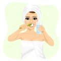 Attractive young woman brushing teeth