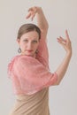 Attractive young woman dancing flamenco with beautiful arms in a pink beige dress Royalty Free Stock Photo
