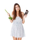 What would you do. An attractive young woman deciding between a stick of celery and a slab of chocolate.