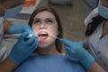 Attractive young woman in a dental clinic with a male dentist.