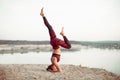 An attractive young woman doing a yoga pose for balance and stretching near the lake high in the mountains Royalty Free Stock Photo