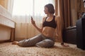 Attractive young woman doing yoga stretching yoga online at home Royalty Free Stock Photo