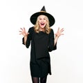 Attractive young woman dressed in witch halloween costume isolated over white background. Sensual Halloween Witch. Royalty Free Stock Photo
