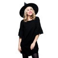 Attractive young woman dressed in witch halloween costume isolated over white background. Sensual Halloween Witch.