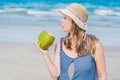 Attractive young woman drinking coconut water on the beach Royalty Free Stock Photo