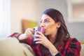 Attractive young woman drinking coffee at home Royalty Free Stock Photo