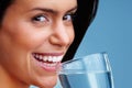 An attractive young woman drinking a glass of water. Macro view of an attractive young woman drinking a glass of water. Royalty Free Stock Photo