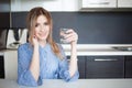 Attractive young woman drinking water in the kitchen. Habits for a healthy lifestyle Royalty Free Stock Photo
