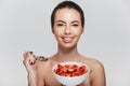 attractive young woman eating cereal breakfast with strawberries Royalty Free Stock Photo