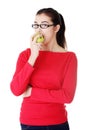 Attractive young woman eating green apple. Royalty Free Stock Photo