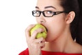 Attractive young woman eating green apple. Royalty Free Stock Photo