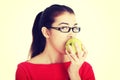 Attractive young woman eating green apple. Royalty Free Stock Photo