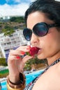 attractive young woman eating strawberries in summer Royalty Free Stock Photo