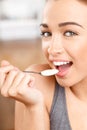 Attractive young woman eating yogurt Royalty Free Stock Photo