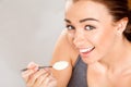 Attractive young woman eating yogurt Royalty Free Stock Photo