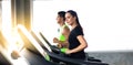 Attractive young woman and female running on treadmill machine at gym sports club. Fitness Healthy lifestye and workout at gym