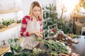 Attractive young woman florist around flowers