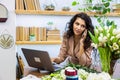 Attractive young woman florist is working in a flower shop. Royalty Free Stock Photo