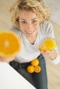 attractive young woman with fresh juice and orange halves