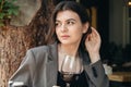 Attractive young woman with a glass of wine in a restaurant. Royalty Free Stock Photo