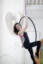 Attractive young woman hanging on the aerial hoop upside down Royalty Free Stock Photo