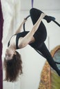 Attractive young woman hanging on the aerial hoop upside down Royalty Free Stock Photo